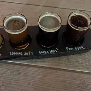 a flight of beers on a serving tray