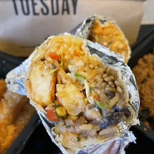 a burrito with rice and vegetables