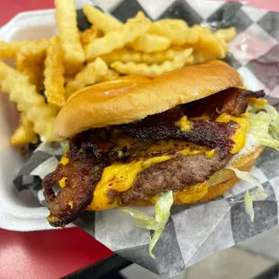 Bacon burger with fries.