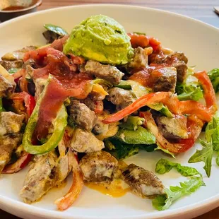 Fajita over spring greens and steak.