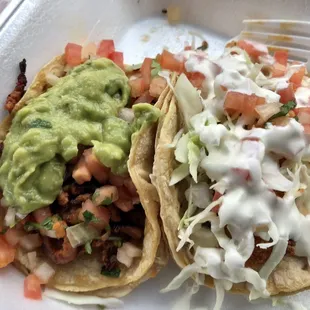 Al pastor taco on left (ehhh), fish taco on right (ok).