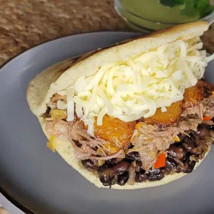 Arepa Pabellon
(Shredded beef, Cheese, black beans, and fried plantain)