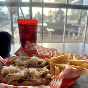 Two Sauerkraut dogs with fries and a fountain drink.
