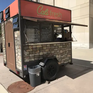 a food truck parked on the side of the street