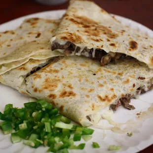 two quesadillas on a paper plate