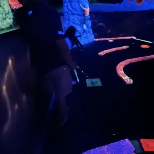 People sitting down to wait for people ahead to finish. No space to wait between holes.