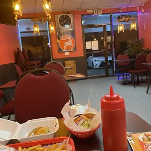 This is on a Friday night 7pm. Sitting area. Very pretty orange lights inside with a couple of clean tables.