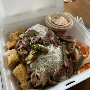 Vermicelli noodles with grilled pork and egg rolls