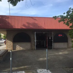 Located in the back of the building, right behind 7/11