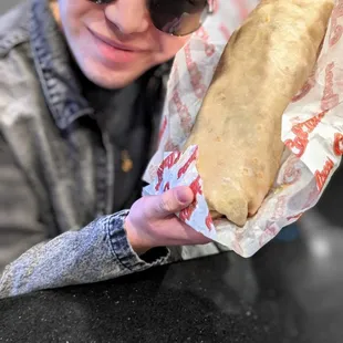 a man holding a sandwich