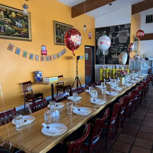 a long table set for a birthday party