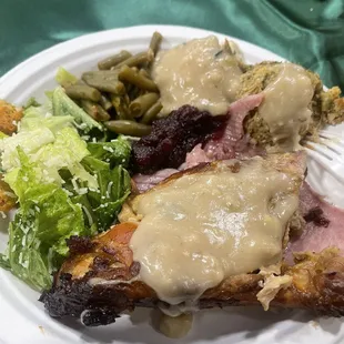 Dressing, garlic mashed potatoes, sting beans, cranberry, turkey, ham, and salad