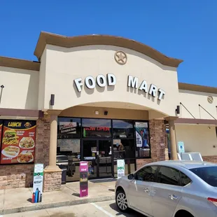 a car parked in front of a food market