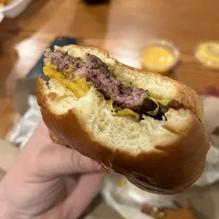a hand holding a sandwich
