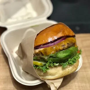 a hamburger in a styrofoam container