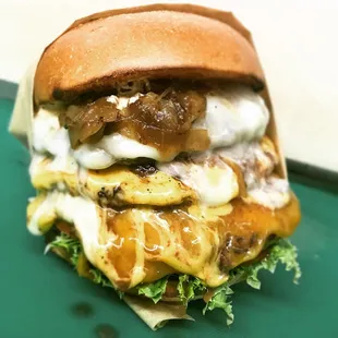 a burger with onions and cheese