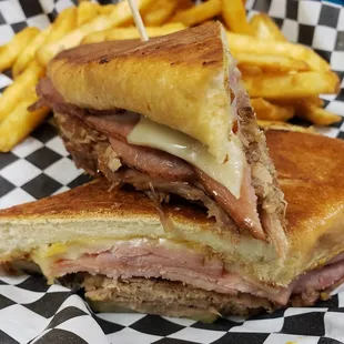 Cubano Jack special! Slow roasted pork, shaved ham, Swiss cheese, yellow mustard and pickles w/ fries
