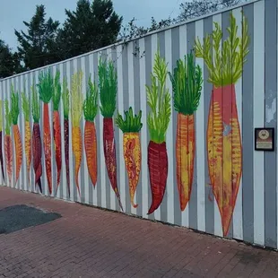 a mural of carrots painted on the side of a building