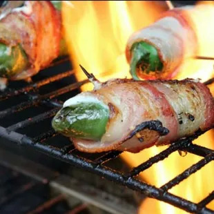 bacon wrapped jalapenos on a grill