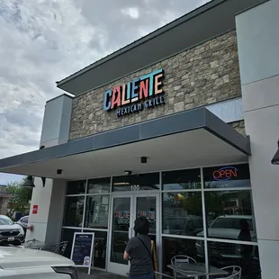 a woman walking out of a restaurant