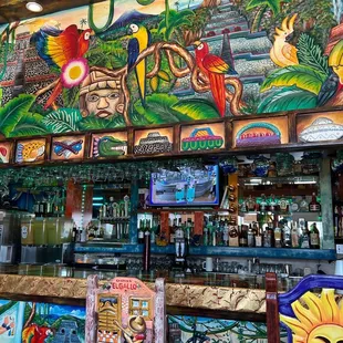 a bar with colorful murals