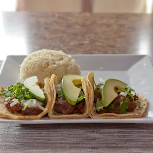 a plate of tacos and rice