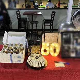 a table with desserts and balloons