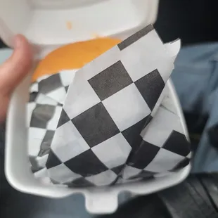 a person holding a takeout container