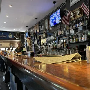 a bar with people sitting at the bar