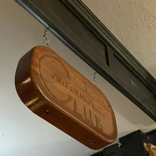 a wooden sign hanging from the ceiling