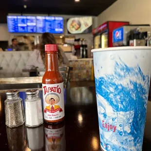 a hot sauce and a cup of hot sauce