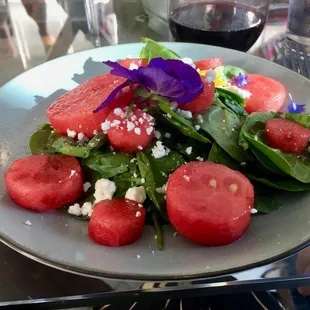 Spinace Salad with watermelon and fresh edible flowers.