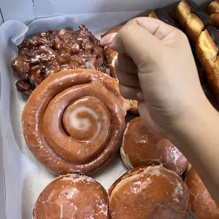a hand grabbing a donut
