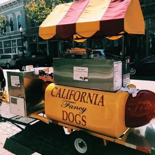 a hot dog cart on a city street