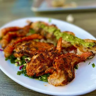 GIANT SHRIMP PLATE (w/CAJUN seasoning) over a Kaleslaw and SEASONED TOMATO &amp; FETA and a side of chimichurri Grillled SHRIMP SKEWERS.
