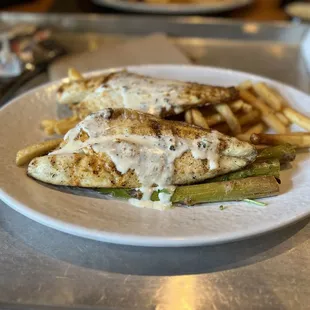 Sea Bass (Branzino) in Garlic Butter Sauce With fries and asparagus