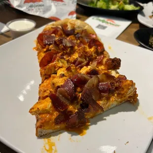 a slice of pizza on a plate