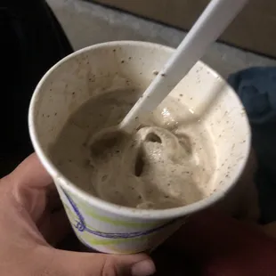  hand holding a cup of ice cream