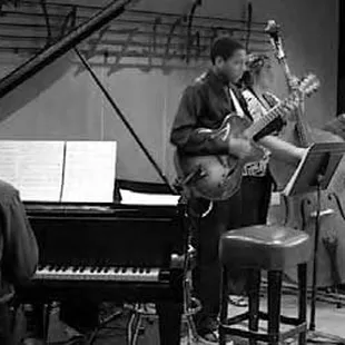 a man playing a guitar and a woman playing a piano