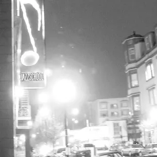 a man sitting on a bench under a street light