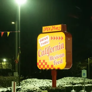 a neon sign in a parking lot