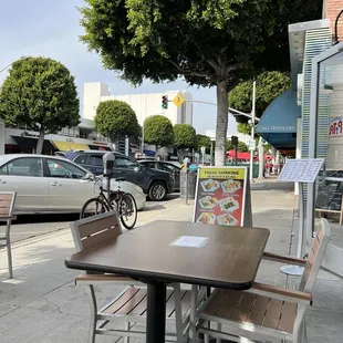 tables and chairs on the sidewalk