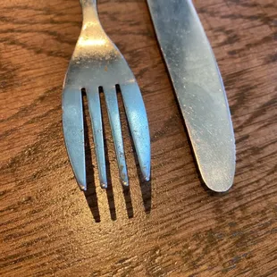 Dirty, used utensils when we seated at the table
