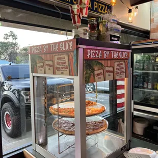 pizzas in a display case