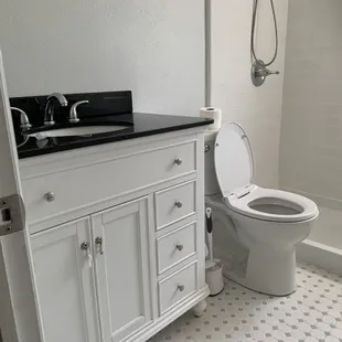 Complete bathroom remodel with new tile flooring, tile shower walls, vanity, recessed lighting beautifully installed