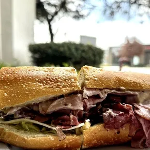 a hand holding a sandwich