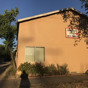 This is the stage complex, view from 25th street and R. Three Penny Theatre entrance is through the gate