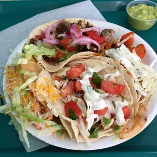 Carnitas, chicken (hard shell), shrimp, and fish tacos.