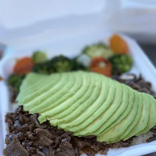 Favorite spot for a quick lunch. Small Beef/Veggie Plate with Avocado.