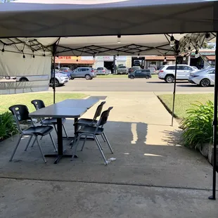 Pop up canopy with tables and chairs for outdoor dining